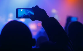 Person holding smartphone at an event